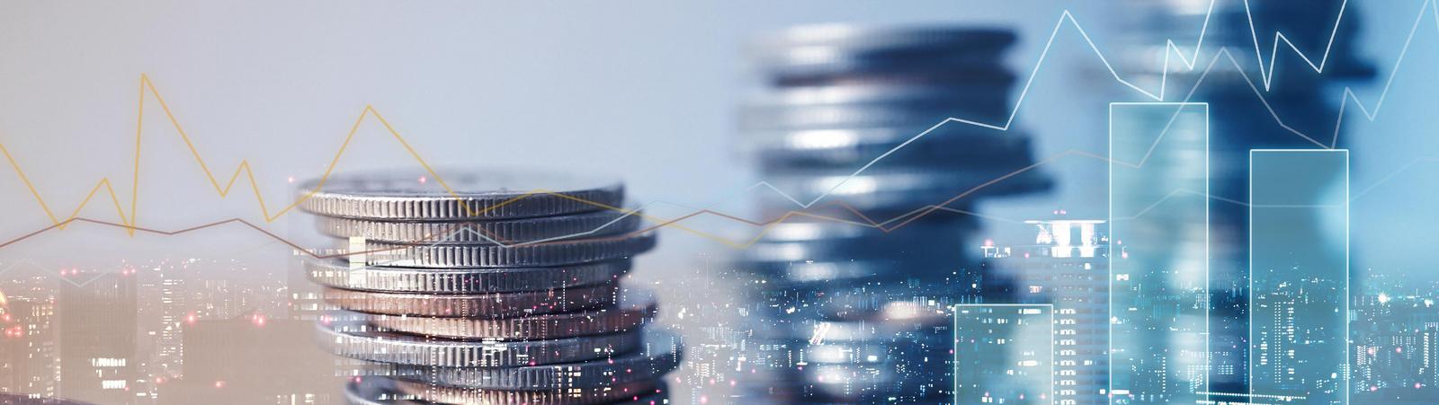 financial graphs and stacks of coins