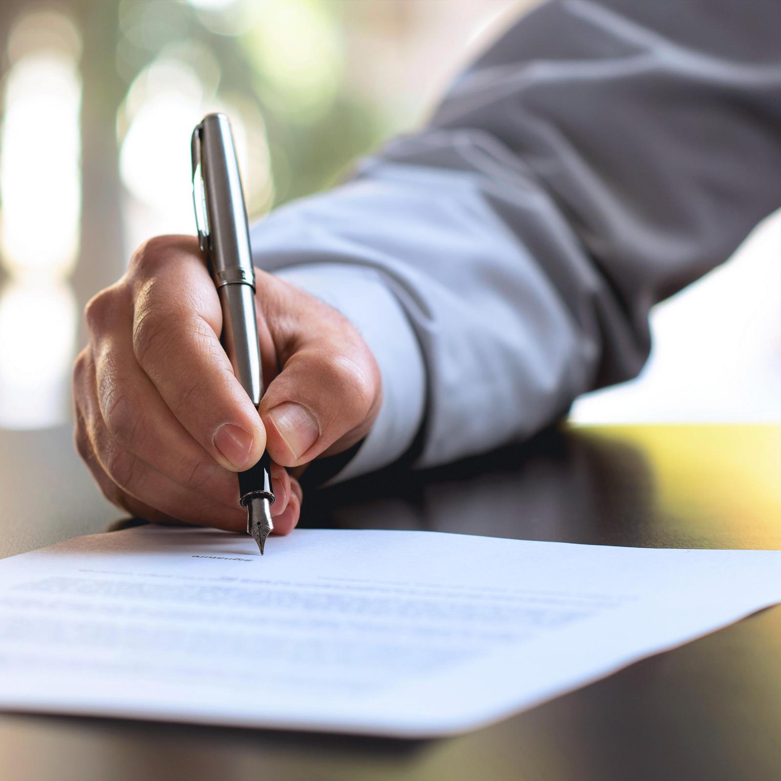 hand of a businessman signing a contract